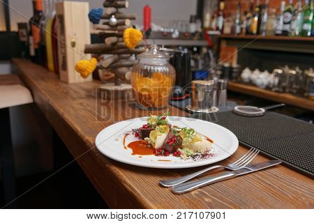 Venison fillet and potato puree served on bar counter