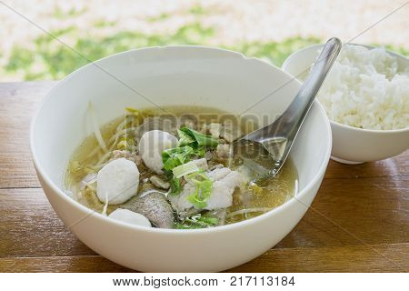 Thailand traditional ekaehla beef soup and cooked rice on the woodden table. Food thai style.