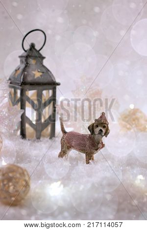 New Year card with toy dog in a fairy forest on winter background with snow and lights. Template greeting card