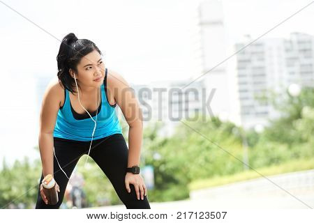 Vietnamese pretty young woman tired after jogging