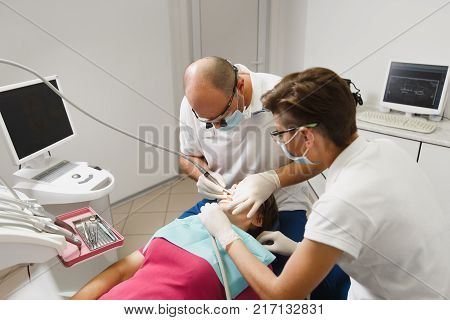 Process Of Preparing And Installing Dental Ceramic Crown. Professional Dentist And Assistant, Lookin