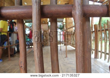 Part of a wooden fance with defocused blured background.