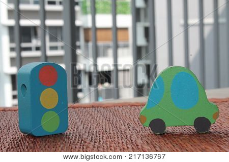 Traditional thai style nature background of brown handicraft weave texture wicker surface for furniture material with green toy car and traffic light on it