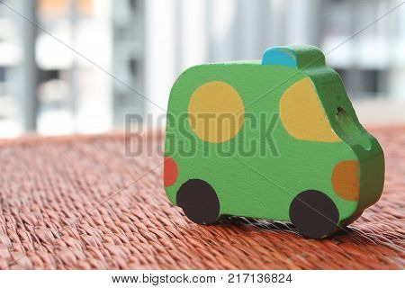 Traditional thai style nature background of brown handicraft weave texture wicker surface for furniture material with green toy car on it
