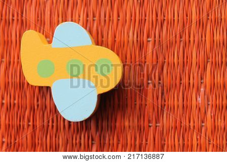 Traditional thai style nature background of brown handicraft weave texture wicker surface for furniture material with yellow toy plane on it