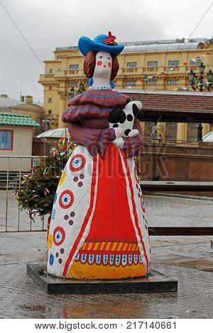 Moscow Russia - February 27 2017: Traditional Dymkovo toy woman with dog as art object at Russian national festival 