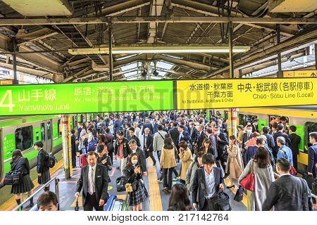 Tokyo, Japan - April 17, 2017: commuters at rush hour in Shinjuku Station. Yamanote Line loop that connects all metro lines and Sobu Line local to a slower metro service that crosses the Yamanote