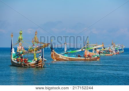 Jembrana Bali Island Indonesia - September 20 2015: Traditional wooden fishing boats mooring in old fishers port on Bali island near Perancak village. Popular place to visit in Jembrana regency.