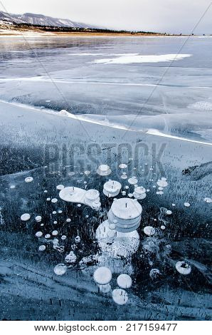 Frozen Lake Baikal. Beautiful mountain near the ice surface on a frosty day. Natural background. Russia. Siberia