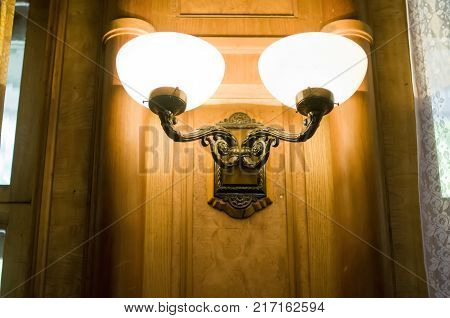 brass sconces on a wooden wall. retro style.