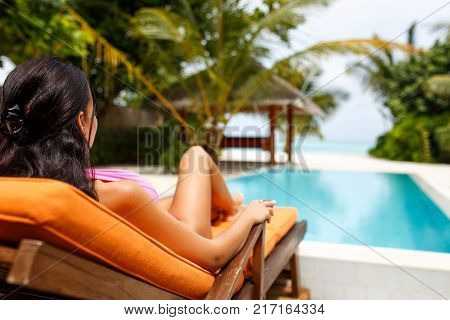 Beautiful young girl wearing bikini in paradise island
