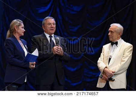 ST. PETERSBURG, RUSSIA - NOVEMBER 16, 2017: Producer Solomon Tencer (center) and artistic director Nadia Tencer (left) greeting the choreographer Oleg Vinogradov during anniversary gala concert