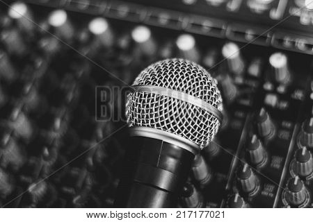 the microphone rests on an audio mixer