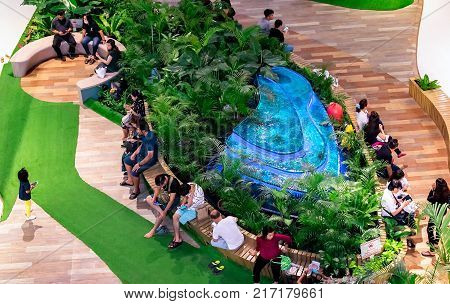 NONTHABURI THAILAND - OCTOBER 08: Tired shoppers takes a break around the fountain in CentralPlaza Westgate shopping mall in Nothaburi Thailand on October 08 2017.