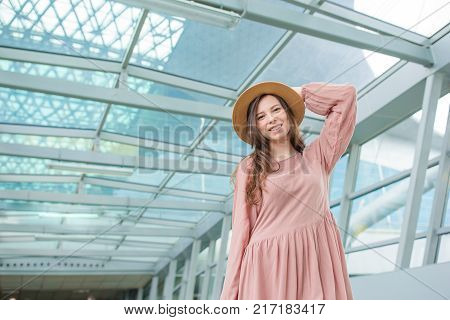 Young woman in international airport walking with her luggage.