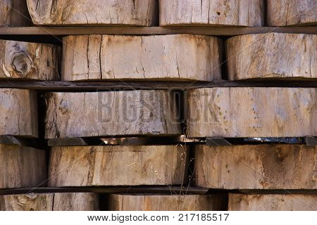 Wood Background Texture. Cross Section Of Tree Trunk. Spili Trees Stumps Stacked In Stacks. Used For