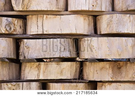 Wood Background Texture. Cross Section Of Tree Trunk. Spili Trees Stumps Stacked In Stacks. Used For