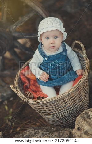 Baby Girl With Ocean Deep Blue Eyes And Pinky Cheek Wearing White Shirt And Jeans Dress And Handmade
