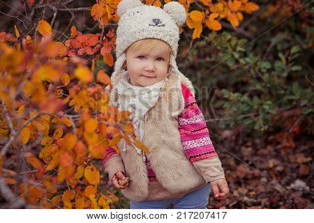 Cute Young Russian Baby Girl Stylish Dressed In Warm White Fur Handmade Jacket Blue Jeans Boots And 