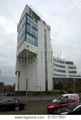 Bracknell, England - Dec 06, 2017: Traffic passes in front of the Bracknell & Wokingham College building, a source of further education for school leavers and adults in Bracknell, England