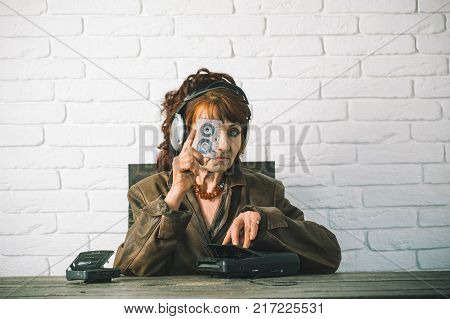Old woman with cassette recorder listen music in headphones. Old school music player radio. Granny dj in headset with cassette player. Spy and operator. Audio book and new technology education.