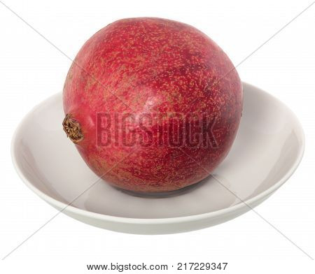 Big Ripe Red Granet or Garnet on a white plate. Fruits of Red Ripe Pomegranate on the White Background. Vegetarian Concept Organic Vitamins Detox Diet.