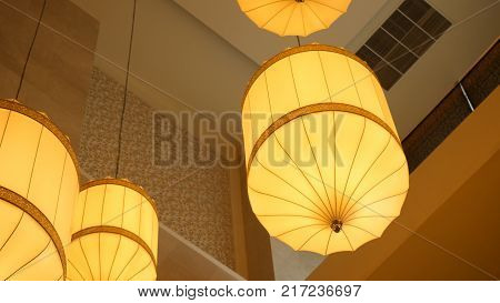 Paper Lanterns Hanging From The Ceiling. Chinese Paper Lantern Hanging From A Ceiling. Yellow Chines