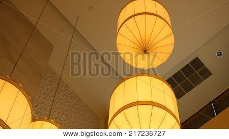 Paper Lanterns Hanging From The Ceiling. Chinese Paper Lantern Hanging From A Ceiling. Yellow Chines