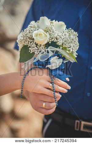 Wedding close picture of bride bouquet of flowers roses hold by couple husband and wife Romantic scene of young family love between man and woman.
