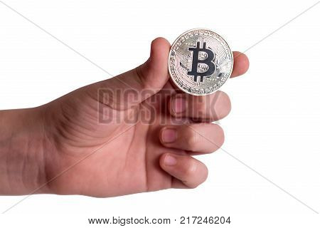 The fingers of the child hold bitcoin. Isolated on white background.