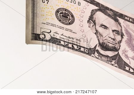 Portrait of Lincoln on a five-dollar bill of the USA on a white background.