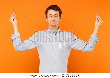 Meditation, Mental Practice. Young Adult Man Closed Eyes And Doing Yoga
