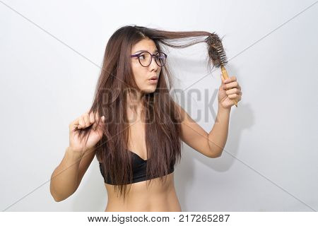 Girl Feeling Nervous With Hair Loss On Comb Isolated On White Background. Female People Stress Looki