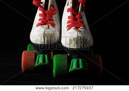 Used Vintage Consumed Roller Skate on a Black Background