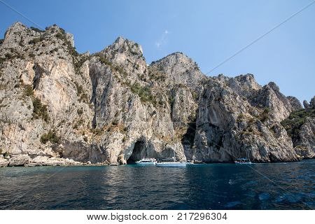 CAPRI ITALY - JUNE 13 2017: Boats with tourists near Grotta Bianca and Grotta Meravigliosa Capri Italy
