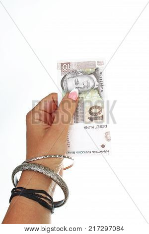 Woman hand holding croatian money bill Kuna on isolated white cutout background. Studio photo with studio lighting easy to use for every concept. Kuna 10 bill.