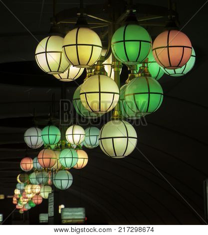 The street lamp in the form of bunches of different colors of round form.