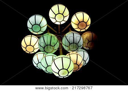 The street lamp in the form of bunches of different colors of round form.
