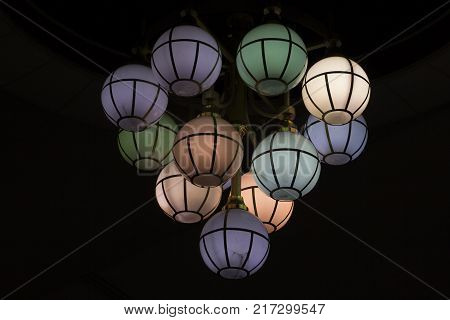 The street lamp in the form of bunches of different colors of round form.
