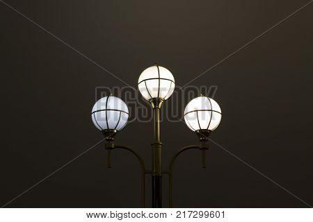 The street lamp in the form of bunches of different colors of round form.