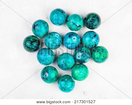 top view of beads from natural Chrysocolla gemstone on gray concrete background