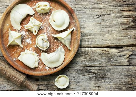 Different types of homemade pasta with stuffing - dumplings vareniki manti tortellini agnolotti ravioli gedza