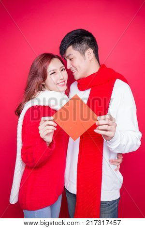 couple show couplets with chinese new year on red background