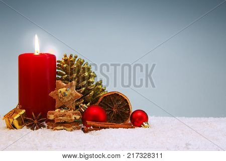 Avent candle and Christmas cookies isolated on gray background.