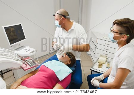 Process Of Preparing And Installing Dental Ceramic Crown. Professional Dentist And Assistant, Lookin