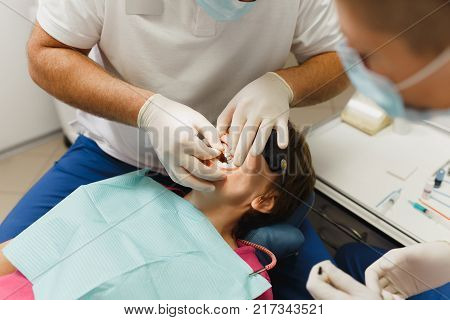 Process Of Preparing And Installing Dental Ceramic Crown. Professional Dentist And Assistant, Lookin
