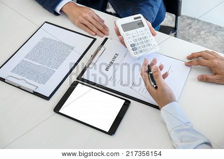 Businessman being analysis and making the decision a car insurance policy Agent man is holding the calculator and waiting for his reply to finish.