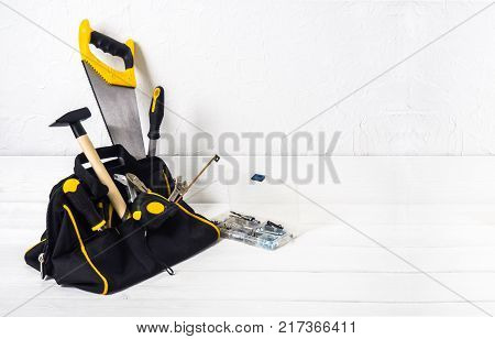 bag with repair tools on white background
