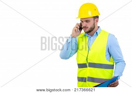 Angry upset young construction engineer yeling at the phone.