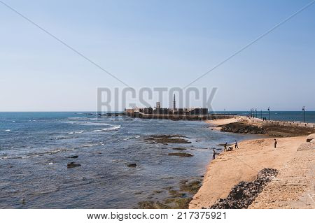 scenic view of seascape with pier and boats under blue clear sky